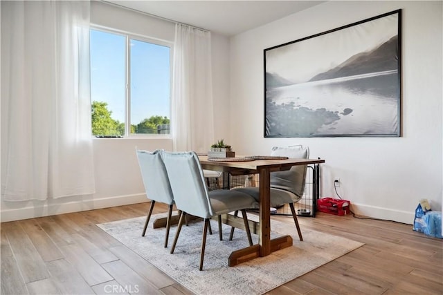 dining space featuring light wood-type flooring