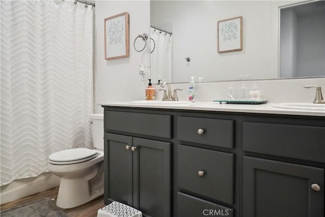 bathroom featuring hardwood / wood-style flooring, vanity, walk in shower, and toilet