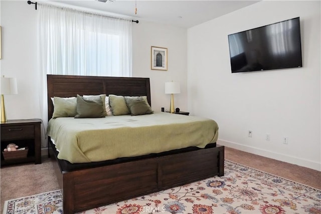 bedroom featuring light carpet