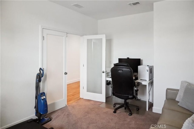 carpeted office featuring french doors