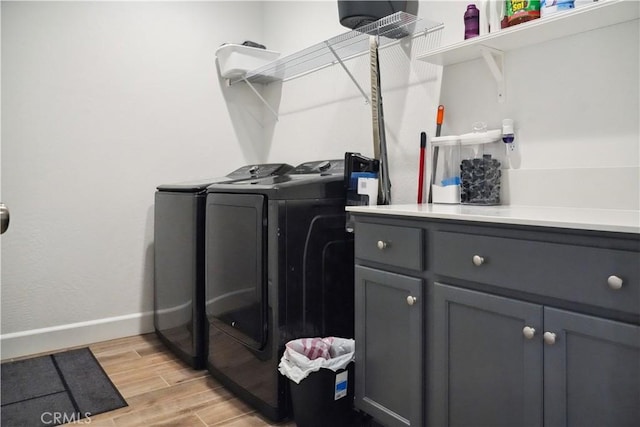 washroom featuring cabinets and separate washer and dryer