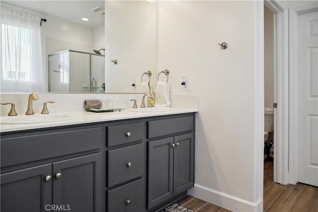 bathroom featuring walk in shower, vanity, and toilet