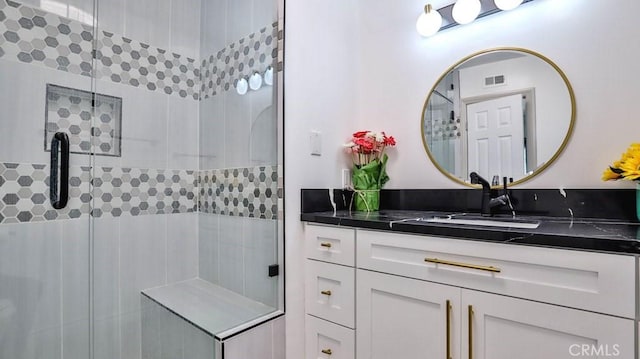 bathroom featuring vanity and an enclosed shower