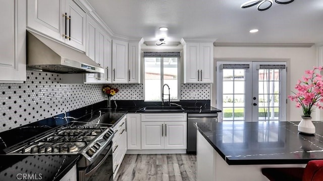 kitchen with sink, crown molding, light hardwood / wood-style flooring, stainless steel appliances, and white cabinets