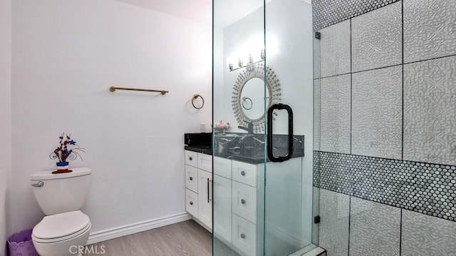 bathroom with vanity, wood-type flooring, walk in shower, and toilet