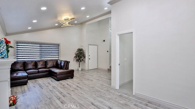 living room featuring high vaulted ceiling, light hardwood / wood-style flooring, and ornamental molding