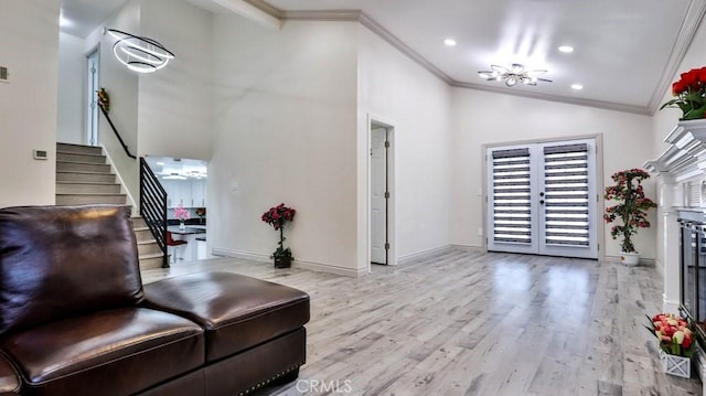 entrance foyer with vaulted ceiling, ornamental molding, french doors, and light wood-type flooring