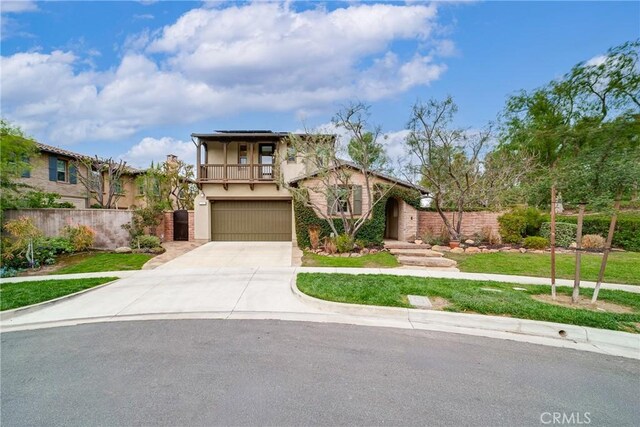 view of front of home featuring a garage, a front yard, and a balcony