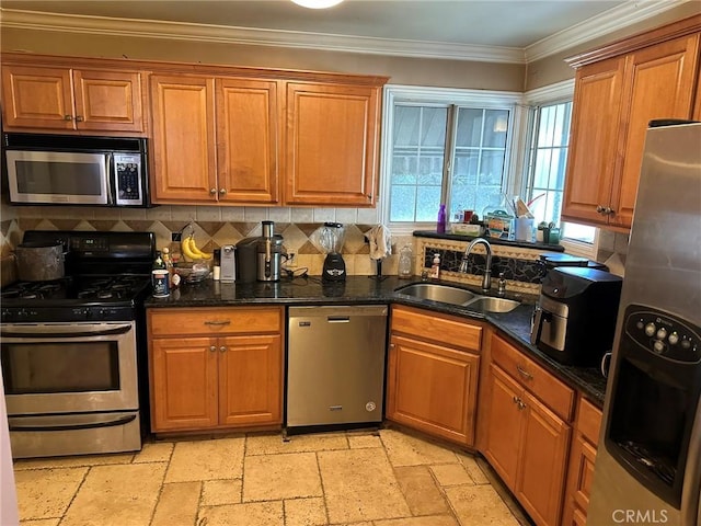 kitchen featuring brown cabinets, stone tile flooring, appliances with stainless steel finishes, ornamental molding, and a sink