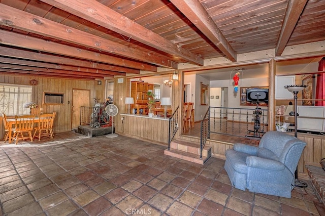 basement with a chandelier, stone tile floors, wooden walls, wood ceiling, and stairs