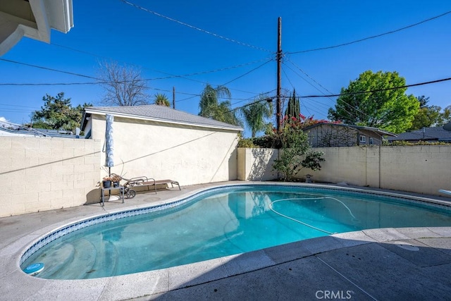 view of swimming pool featuring a fenced in pool, a fenced backyard, and a patio