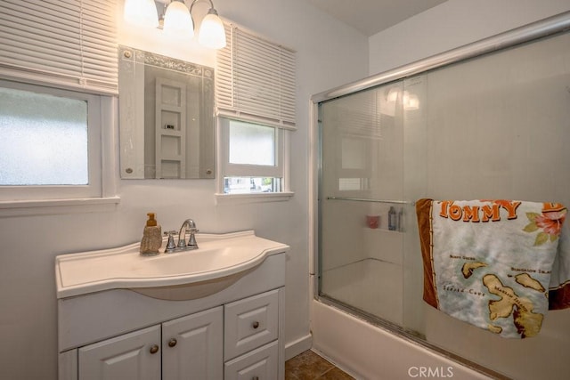 bathroom with enclosed tub / shower combo and vanity