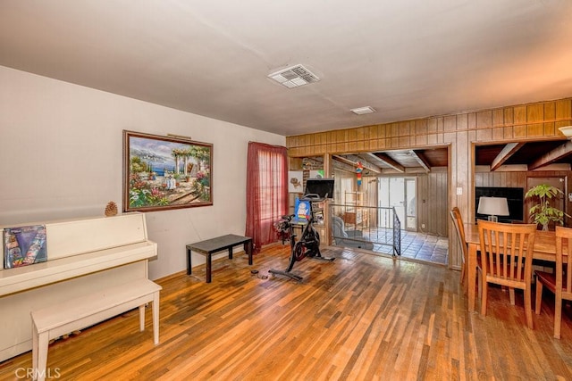 exercise room featuring visible vents and wood finished floors