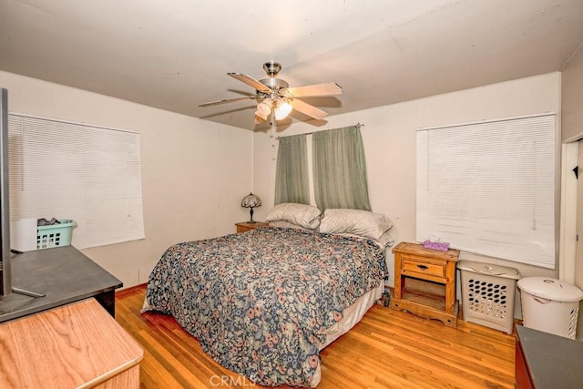 bedroom featuring a ceiling fan and wood finished floors