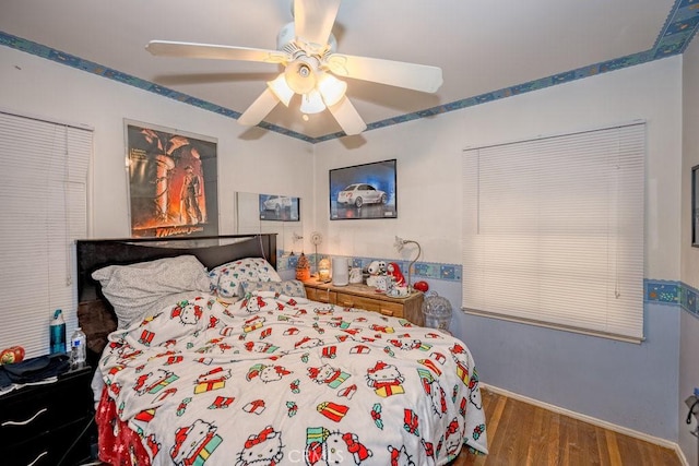 bedroom with a ceiling fan and wood finished floors
