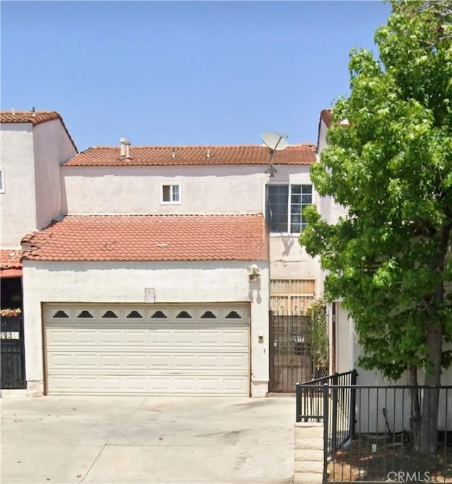 mediterranean / spanish house with a garage