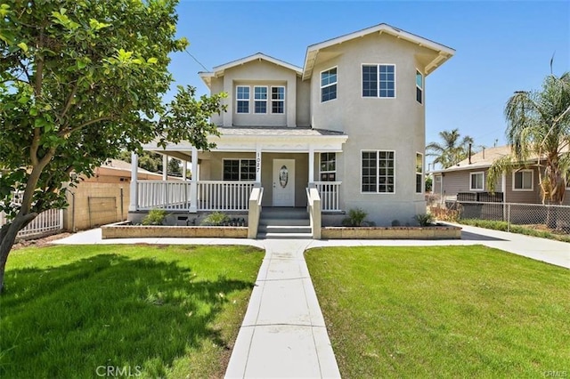 view of front facade with a front lawn and covered porch