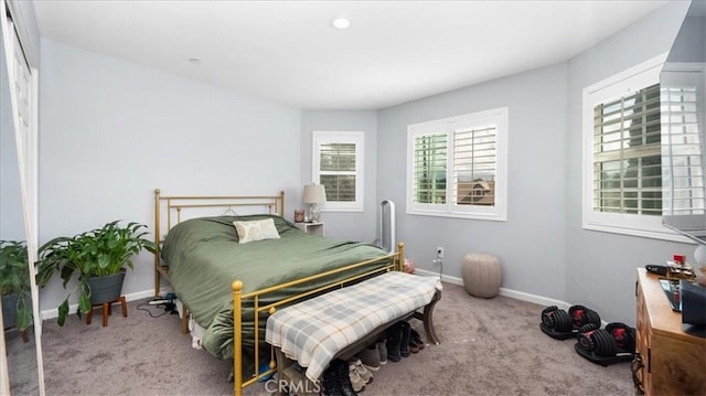 bedroom with carpet flooring and baseboards