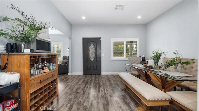 foyer entrance featuring visible vents, baseboards, recessed lighting, and wood finished floors