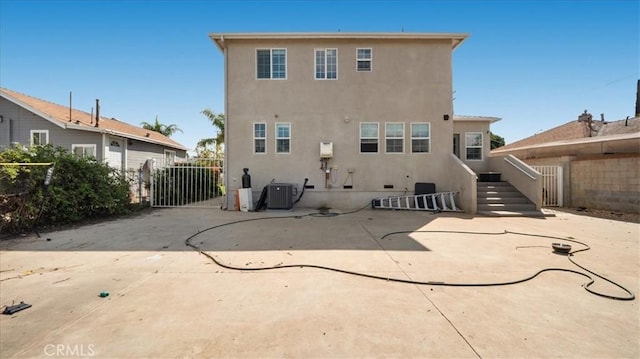 back of house featuring cooling unit, a patio, stucco siding, and fence