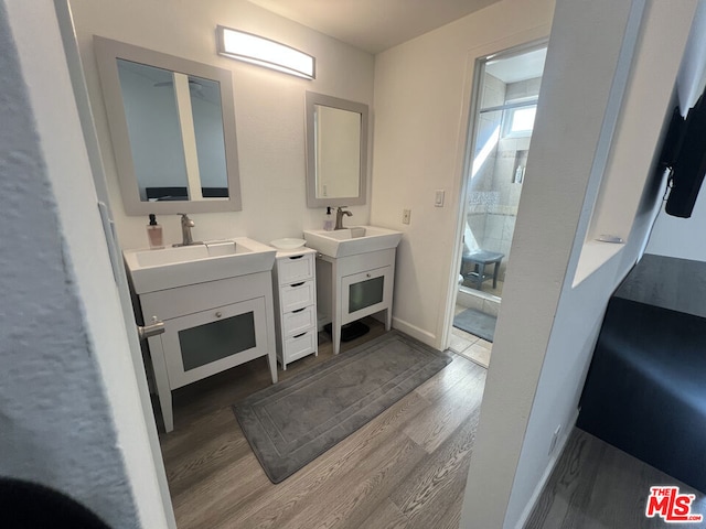 bathroom featuring vanity, hardwood / wood-style floors, and a shower