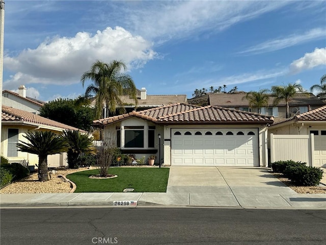 mediterranean / spanish-style house featuring a front lawn and a garage