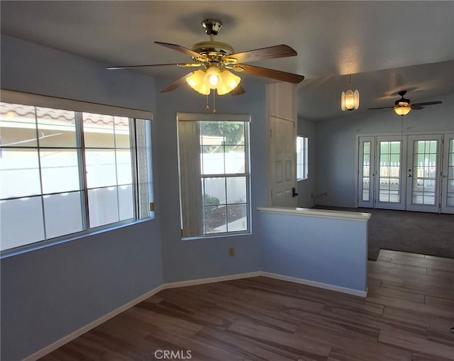 kitchen featuring kitchen peninsula, vaulted ceiling, dark hardwood / wood-style floors, and ceiling fan