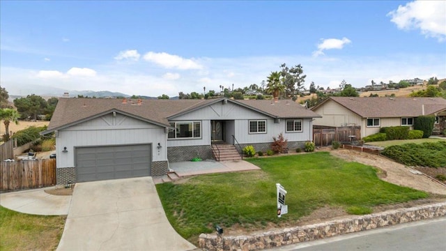 ranch-style house with a garage and a front lawn