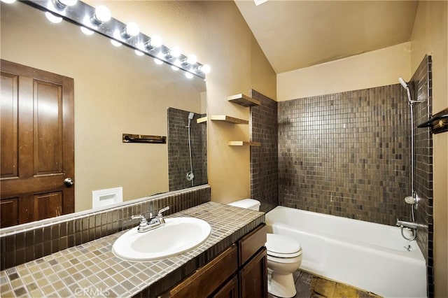 full bathroom with vanity, tiled shower / bath combo, and toilet