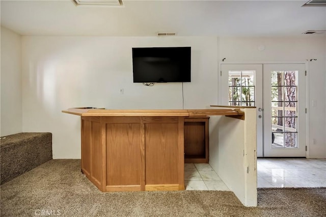 bar with light colored carpet and french doors