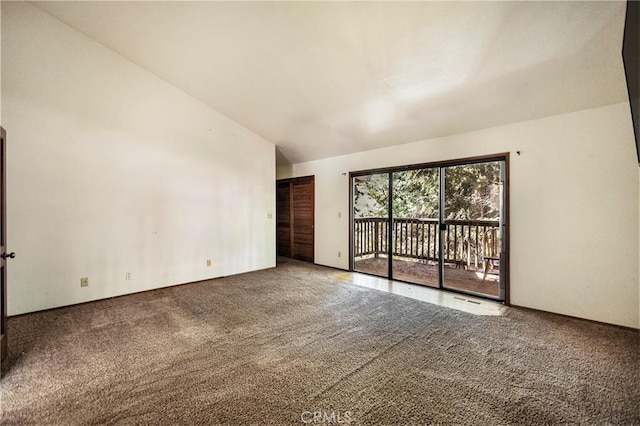 unfurnished room with lofted ceiling and carpet flooring