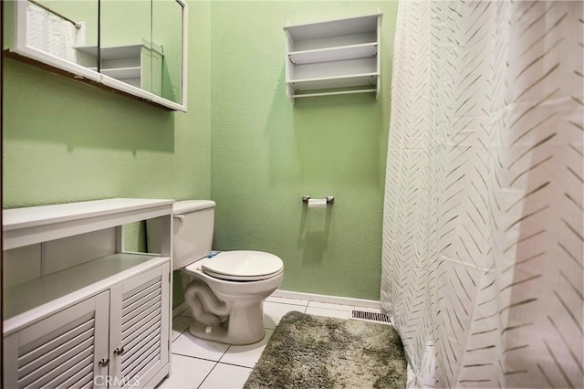 bathroom with tile patterned flooring, a shower with shower curtain, and toilet