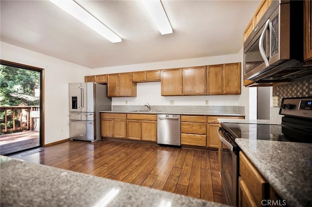 kitchen featuring appliances with stainless steel finishes, sink, and dark wood-type flooring