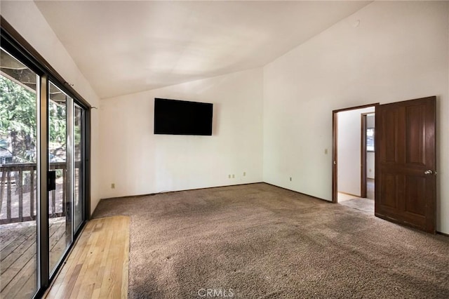 empty room with vaulted ceiling and light carpet