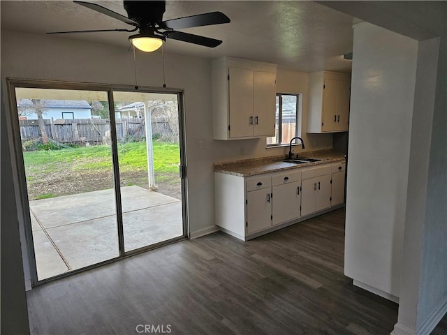 kitchen featuring white cabinetry, sink, dark wood-type flooring, and ceiling fan