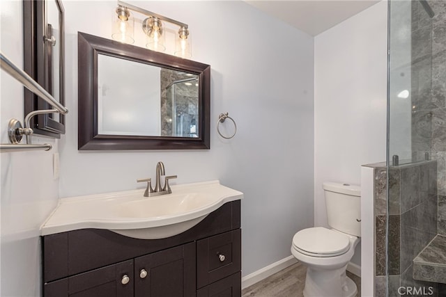 bathroom with vanity, hardwood / wood-style flooring, toilet, and walk in shower