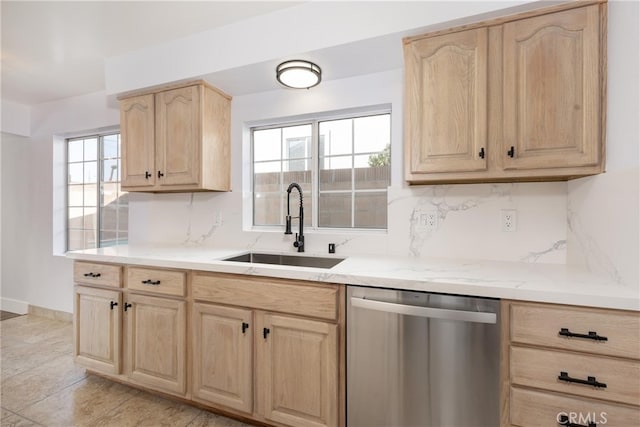 kitchen featuring light brown cabinetry, dishwasher, sink, and backsplash