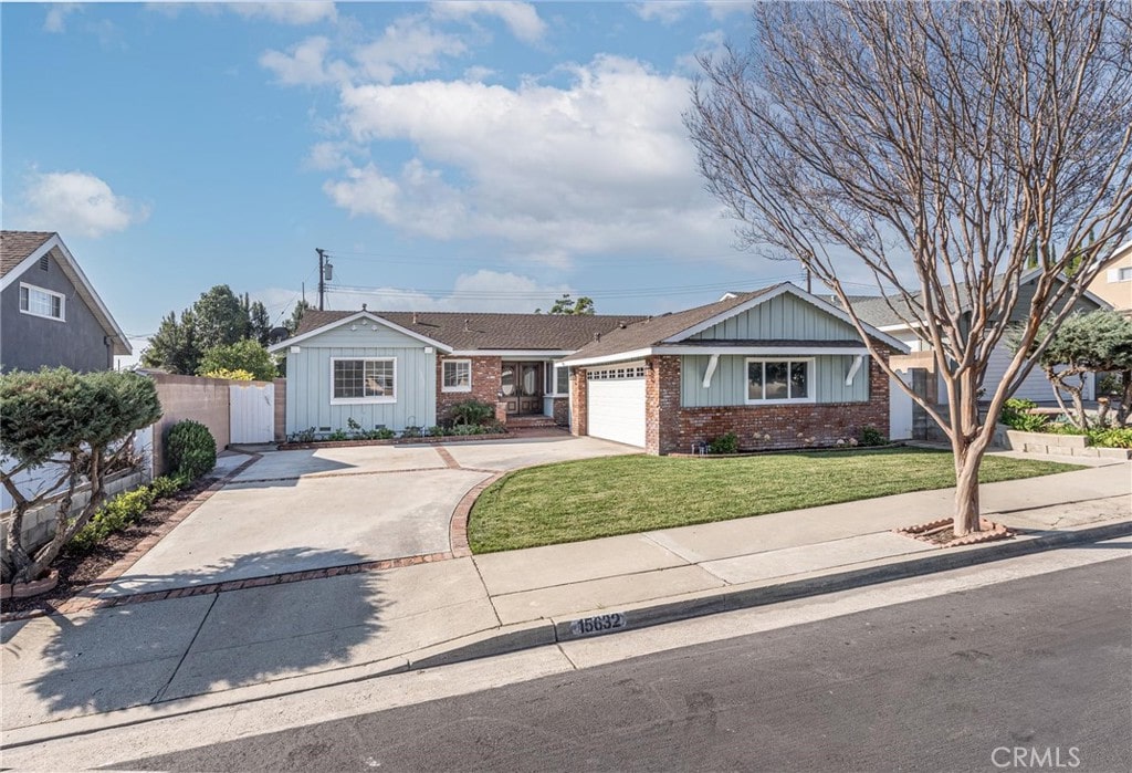 ranch-style home with a garage and a front yard