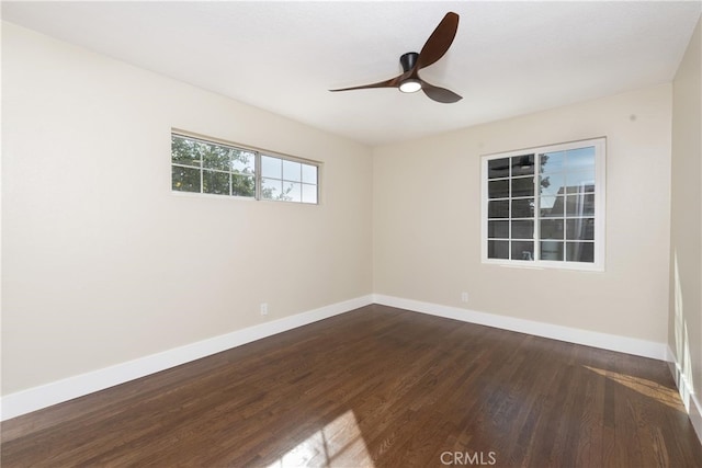 unfurnished room featuring dark wood-type flooring and ceiling fan