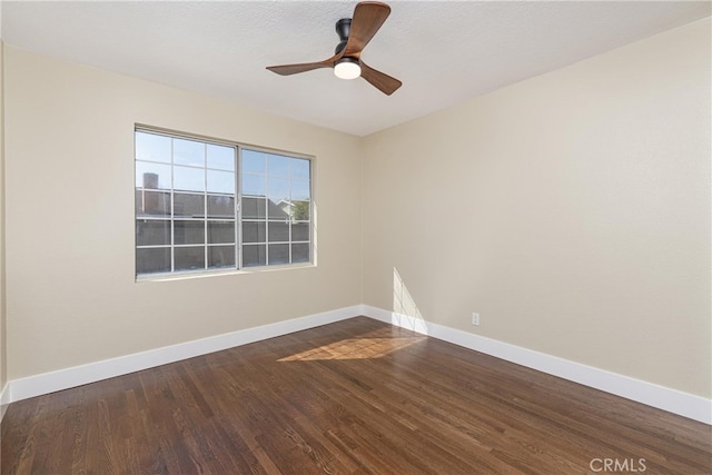 unfurnished room with dark hardwood / wood-style floors and ceiling fan