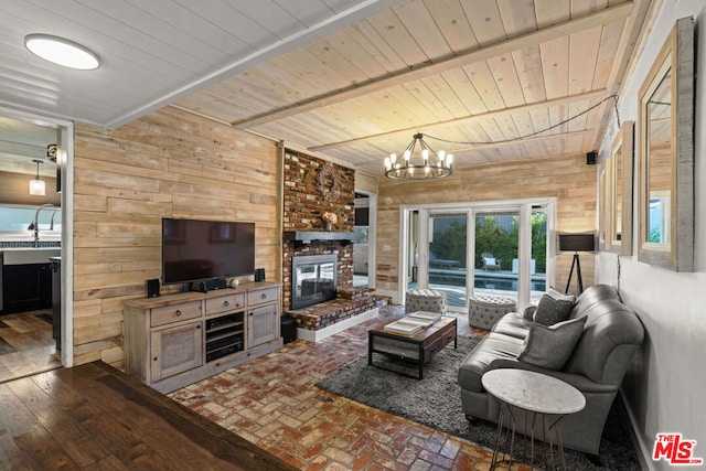 living room featuring beamed ceiling, wooden ceiling, a fireplace, and wood walls