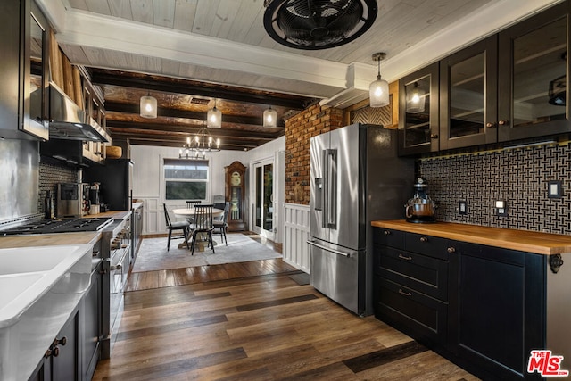 kitchen with wooden counters, hanging light fixtures, range hood, high quality appliances, and dark hardwood / wood-style flooring