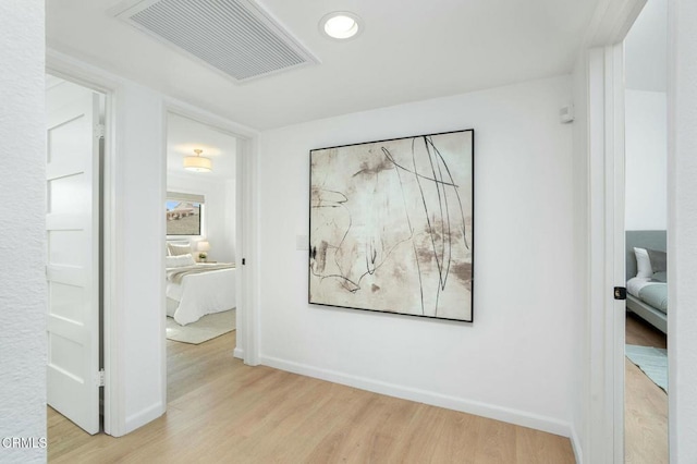 hallway with light hardwood / wood-style flooring