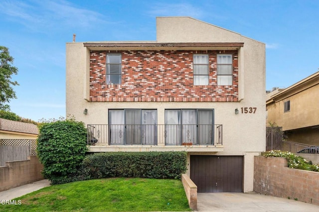 back of property with a garage and a lawn