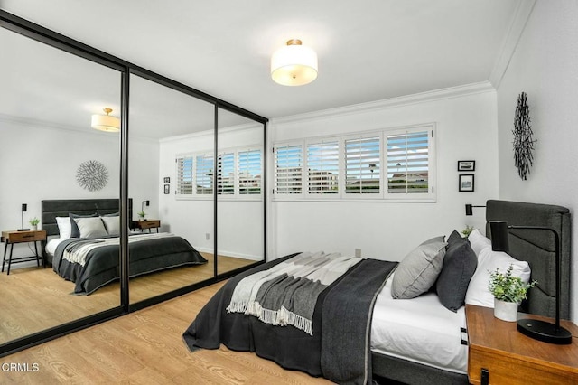 bedroom with multiple windows, hardwood / wood-style floors, and a closet