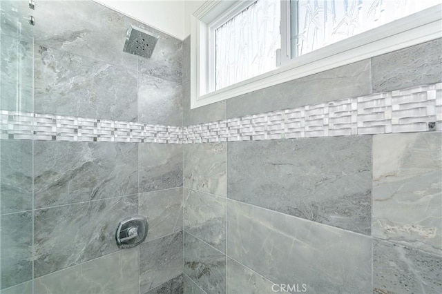 interior details with a tile shower