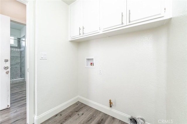 laundry room featuring hookup for a gas dryer, cabinets, washer hookup, and light hardwood / wood-style floors