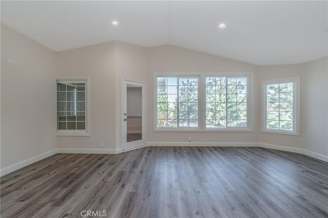 spare room with lofted ceiling and hardwood / wood-style floors