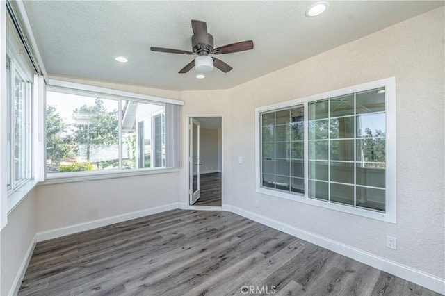 interior space with dark wood-type flooring and ceiling fan