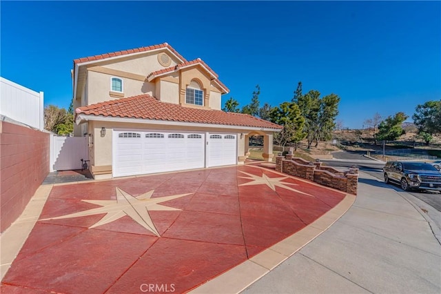 mediterranean / spanish-style home featuring a garage